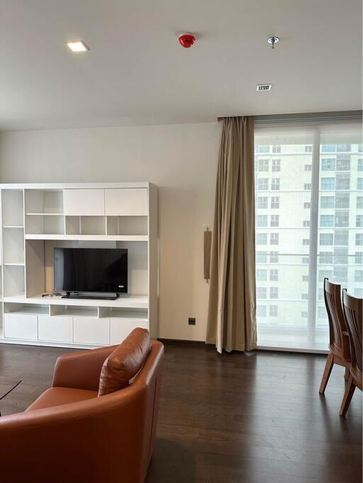 Modern living room with leather seating and entertainment center