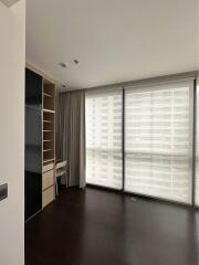 Living room with large windows and built-in shelving