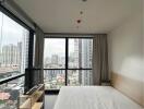 Bedroom with large windows and city view