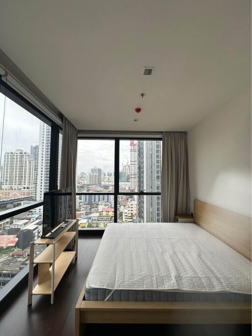 Bedroom with large windows and city view