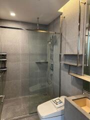 Modern bathroom with glass shower doors and contemporary fixtures