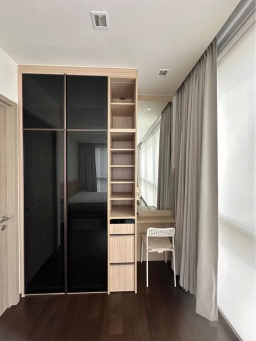 Modern bedroom with wardrobe, shelves, desk and chair