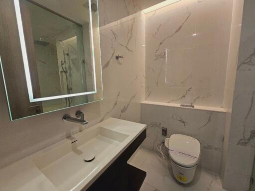 Modern bathroom with illuminated mirror and rainfall shower