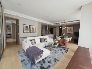 Modern living room with a white sectional sofa, glass coffee table, and an adjacent dining area