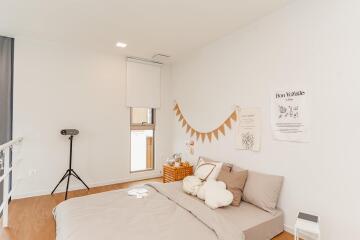 Cozy and minimalistic bedroom with a comfortable bed and wall decorations