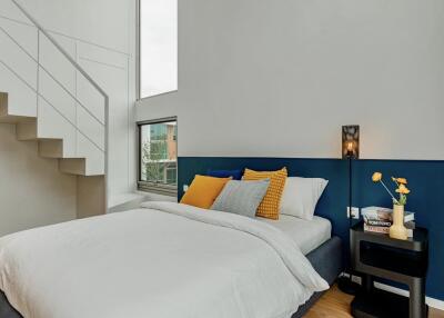 Modern bedroom with staircase and decor