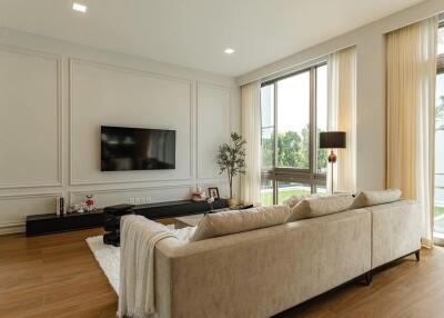 Modern living room with a large sofa and wall-mounted TV