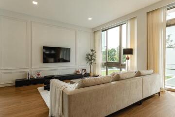 Modern living room with a large sofa and wall-mounted TV