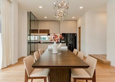 Modern dining area with a wooden table and contemporary chandelier