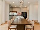 Modern dining area with a wooden table and contemporary chandelier