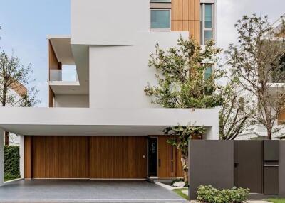 Modern multi-story home exterior with large windows and wood accents