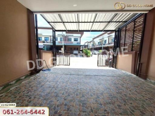 Spacious garage with tiled flooring and open view of neighborhood