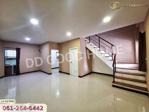 Spacious living room with staircase and glossy tiled floor