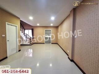 Spacious living room with staircase and large tiled floor