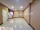 Spacious living room with staircase and large tiled floor