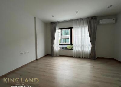 Empty bedroom with large window and curtains