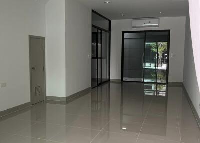 Spacious main living area with tiled flooring and large windows