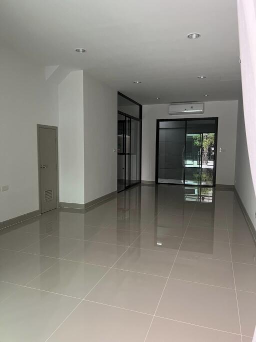 Spacious main living area with tiled flooring and large windows