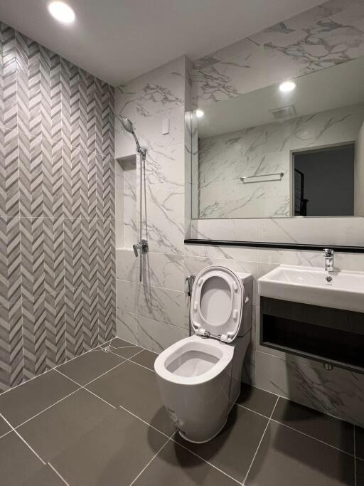 Modern bathroom with tiled shower and large mirror