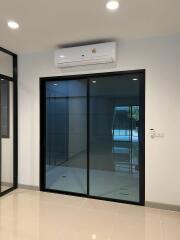 Modern living room with sliding glass doors and air conditioning unit