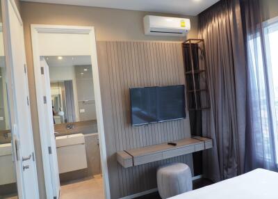 Modern bedroom with wall-mounted TV and air conditioning unit