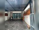 Covered garage with marble flooring and large sliding doors