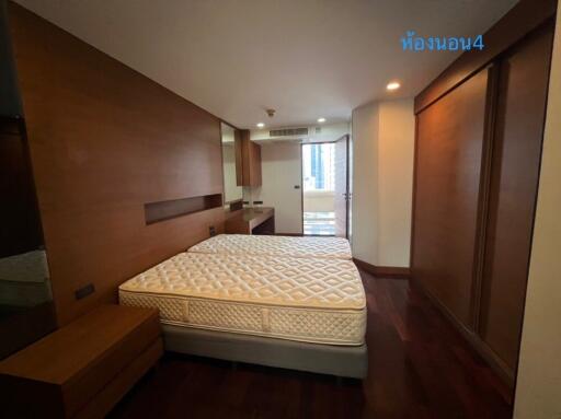 Spacious bedroom with wooden furniture and large window