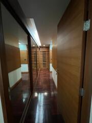 Modern hallway with wooden doors and reflective surfaces