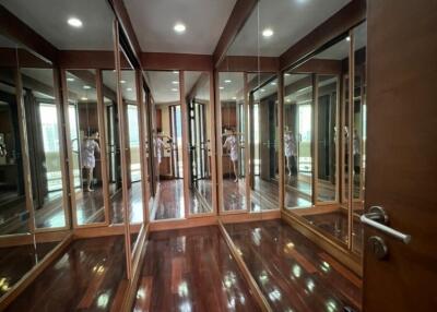 Spacious walk-in closet with mirrored doors