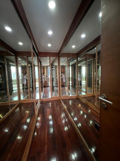 Spacious walk-in closet with mirrored doors