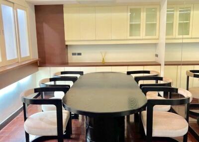 Modern dining area with glass table and stylish chairs