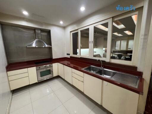 Modern kitchen with red countertops and stainless steel appliances