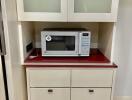 kitchen with microwave and cabinets