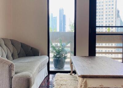 Living room with a sofa, coffee table, and city view