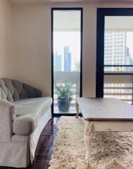 Living room with a sofa, coffee table, and city view