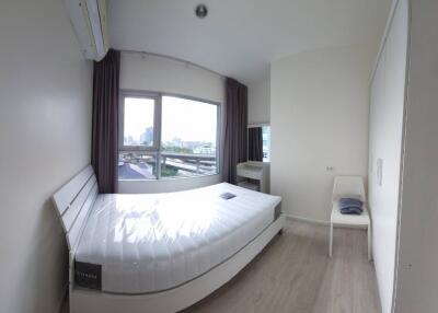 Modern bedroom with large windows and natural light