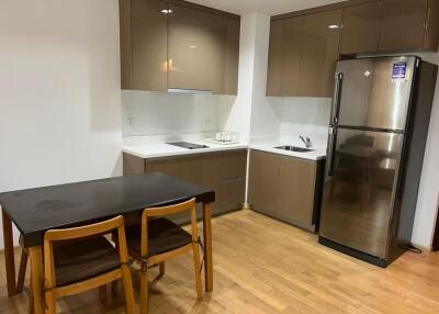 Modern kitchen with wooden cabinets and dining area