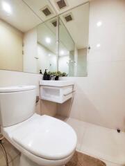 Modern bathroom with wall mirror and white fittings