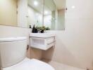 Modern bathroom with wall mirror and white fittings