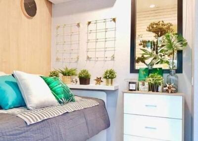 Bright and modern bedroom with bed, plants, and decorative elements