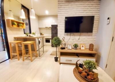 Modern living room and kitchen area with natural light