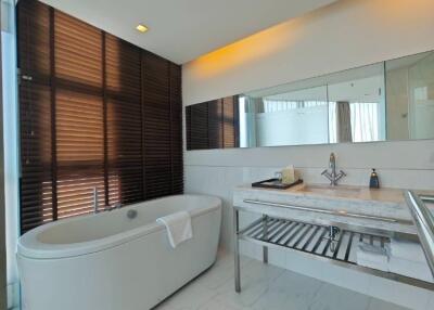 Modern bathroom with a freestanding tub and marble countertops