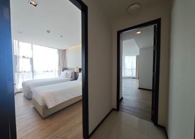 Spacious bedroom with two beds and large windows