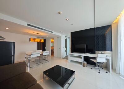 Modern living room with open kitchen, dining and workspace