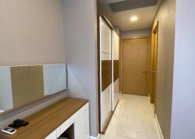 Well-lit hallway with storage and a dressing table