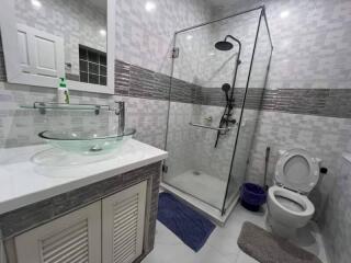 Modern bathroom with glass shower and vessel sink