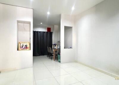 Spacious living area with adjacent dining space and high ceiling