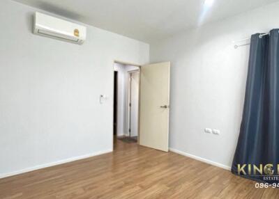 Empty bedroom with wooden floor and air conditioner