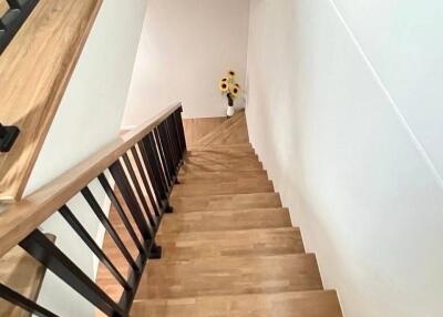 Wooden staircase with black railings