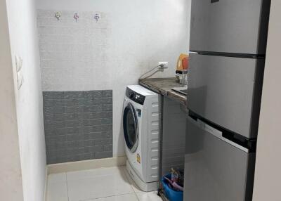 Compact laundry room with washing machine and refrigerator